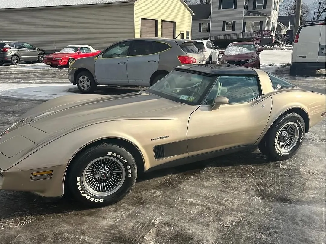 A gold and tan Corvette in the lot