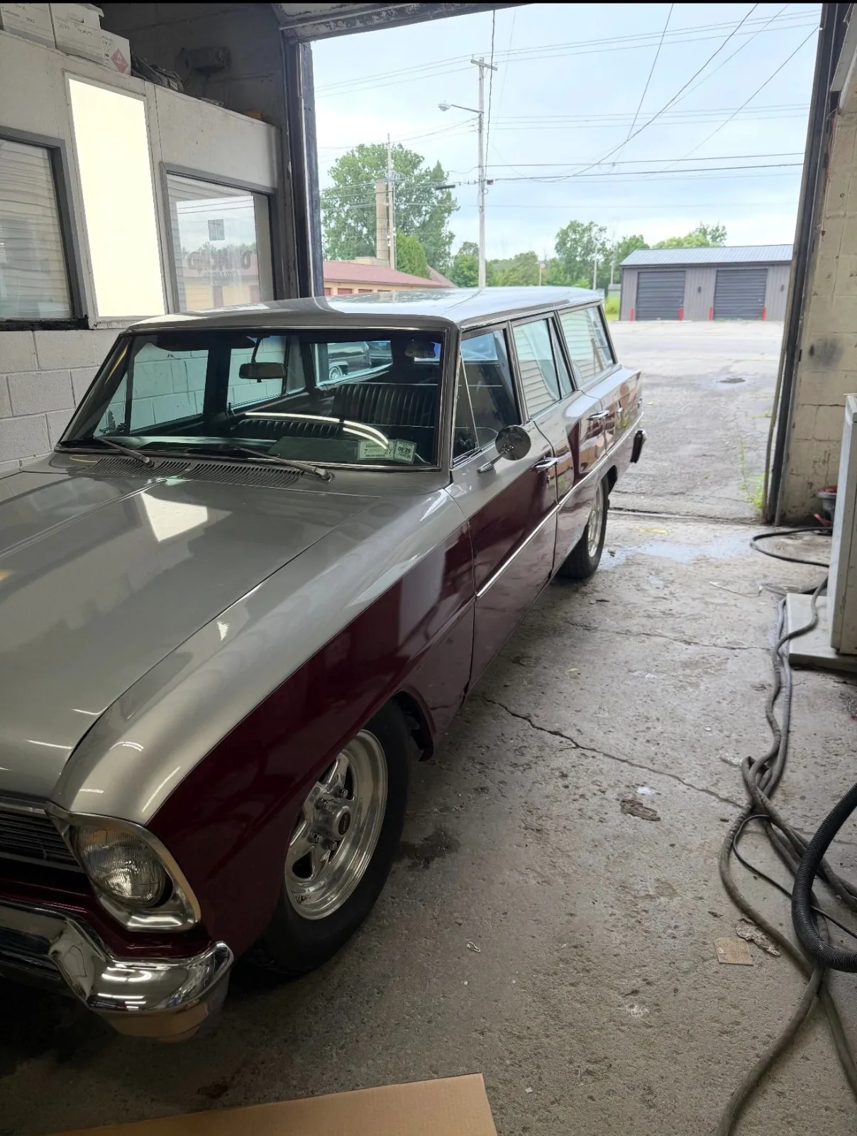 The two-tone Chevy wagon in the open bay door